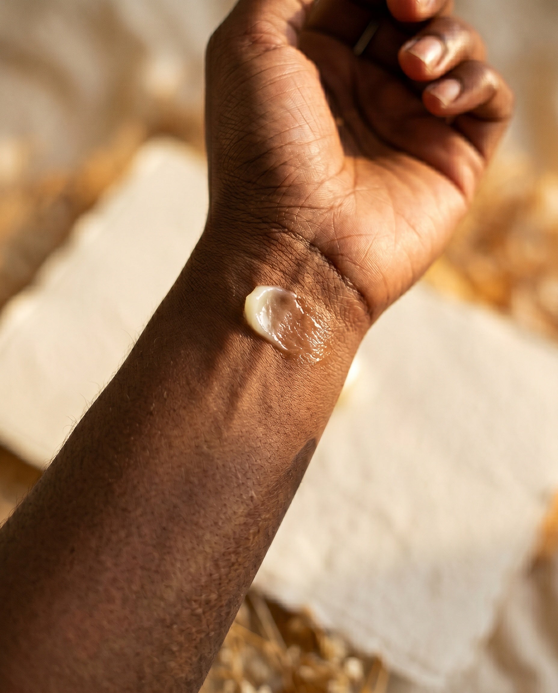 A wrist with the balm freshly applied.